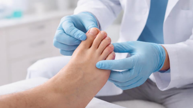 Professional ingrown toenail treatment podiatrist using a medical tool to carefully repair a damaged nail.